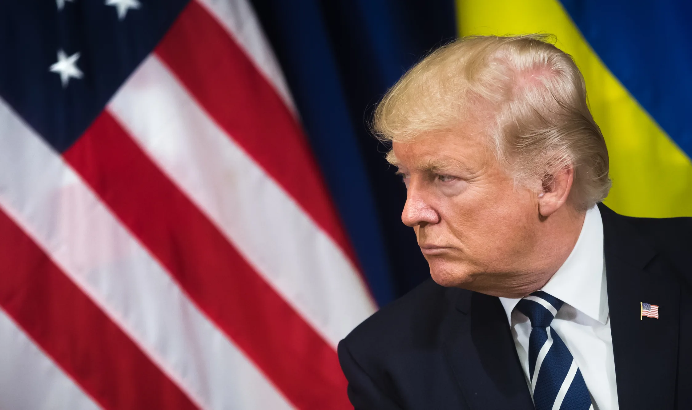 A portrait of Donald Trump with the US and Ukrainian flags, visualizing his role in the complex security challenges facing the West