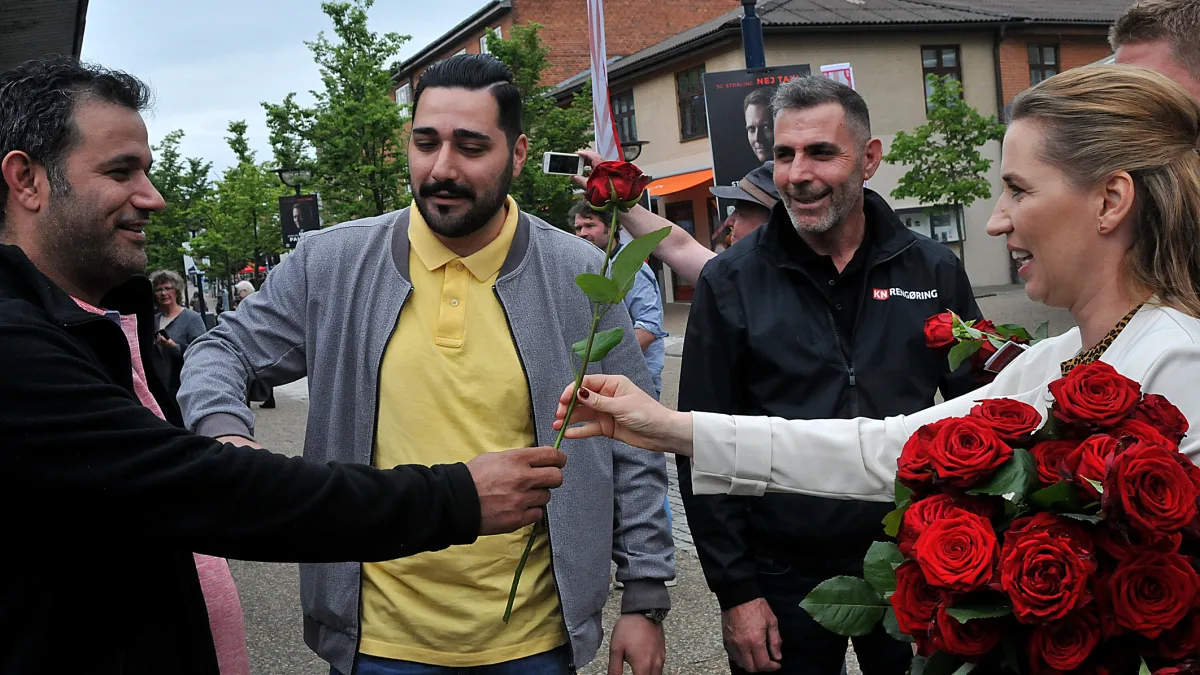 Danish Prime Minister Mette Frederiksen engaging with voters, symbolizing the public debate on Europe's immigration policies.