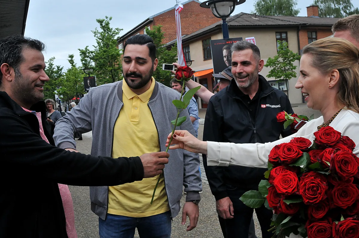 Danish Prime Minister Mette Frederiksen engaging with voters, symbolizing the public debate on Europe's immigration policies.