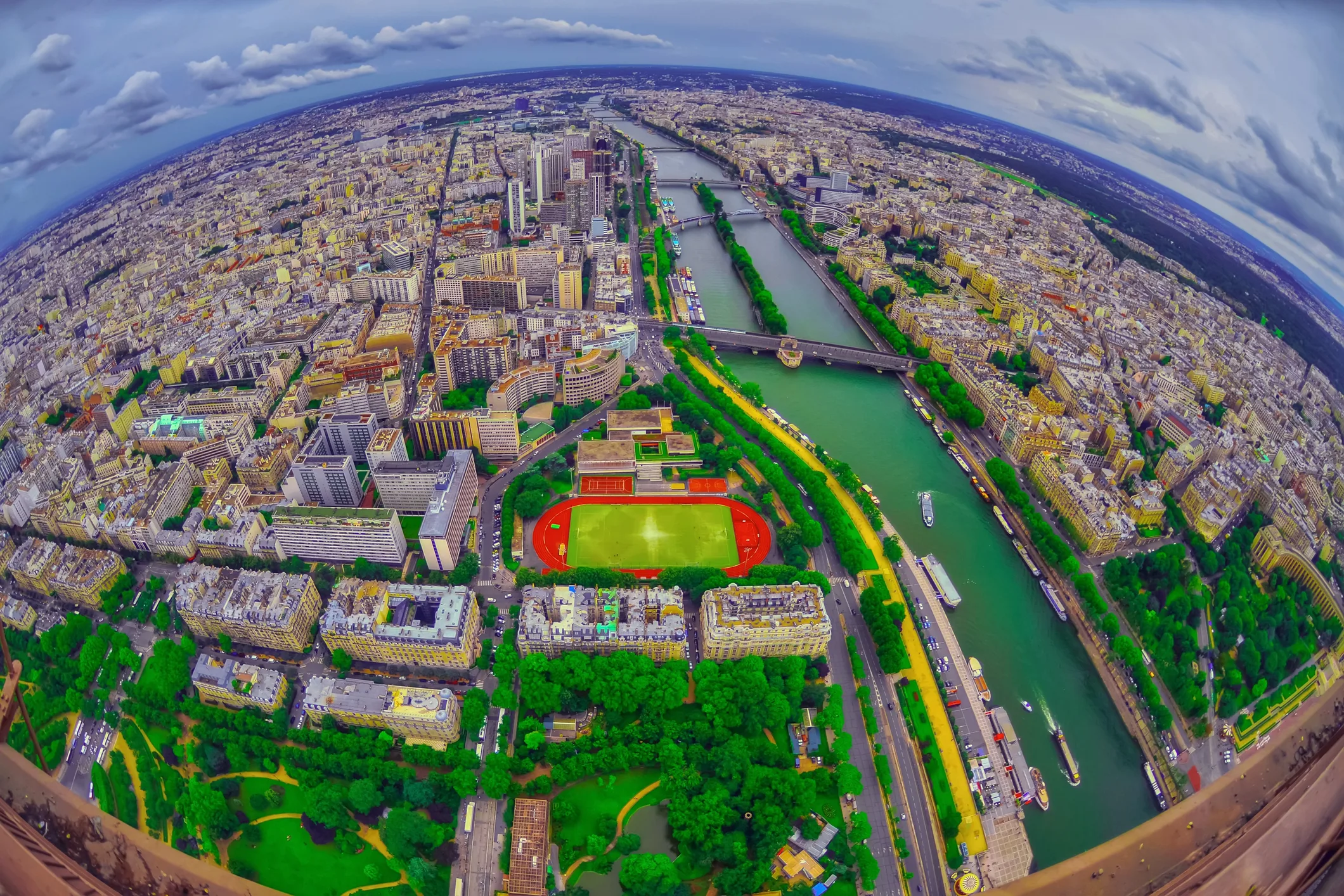 An aerial view of Paris with the Seine River and dense urban neighborhoods, a classic example of urban planning