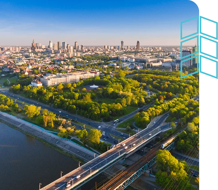 Aerial view of a vibrant city with a river and bridge, symbolizing investment and urban development.