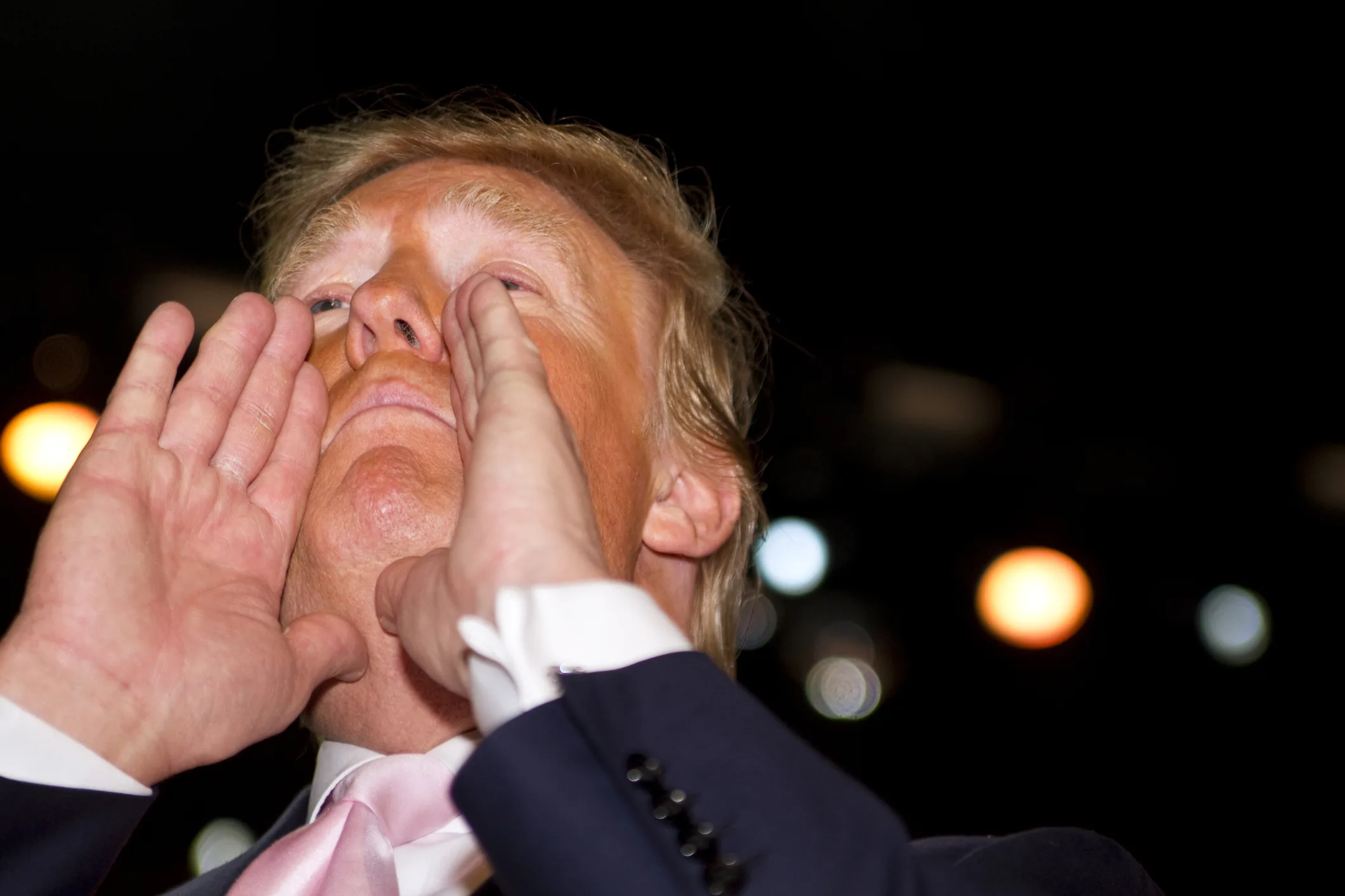 Donald Trump gesturing and shouting during a public appearance, symbolizing the aggressive tactics behind the lopsided US-EU trade deal.