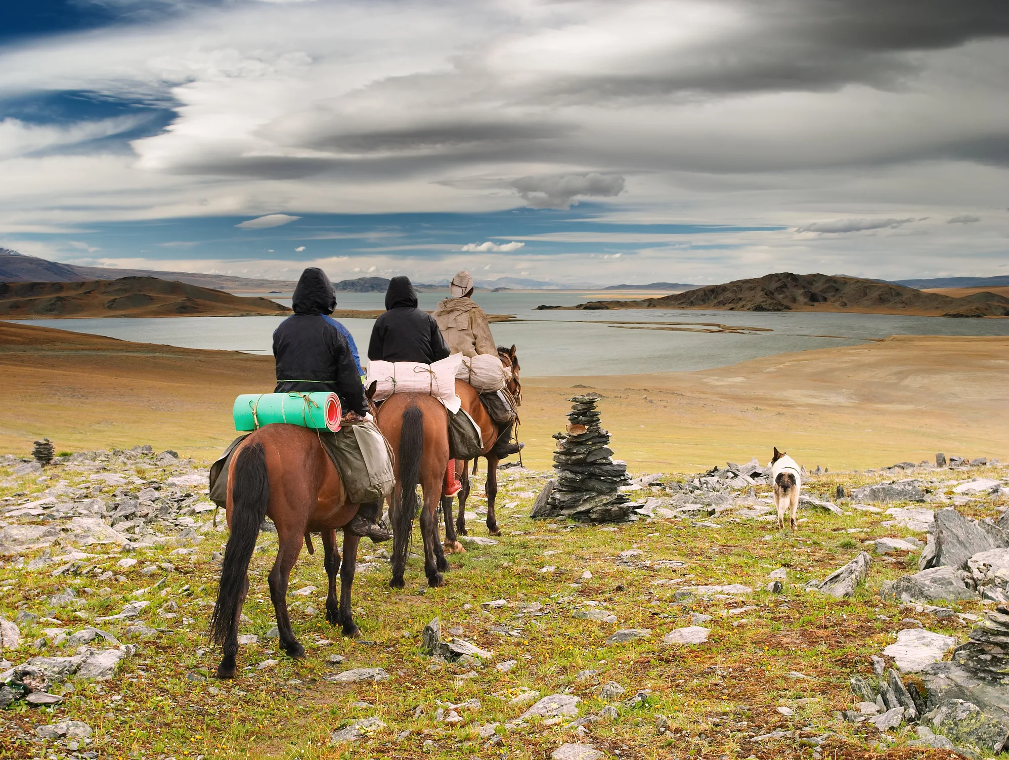 Mongolian nomads on horseback overlooking a vast steppe landscape near a lake, symbolizing rural connectivity, digital transformation, and the evolving rural-urban relationship