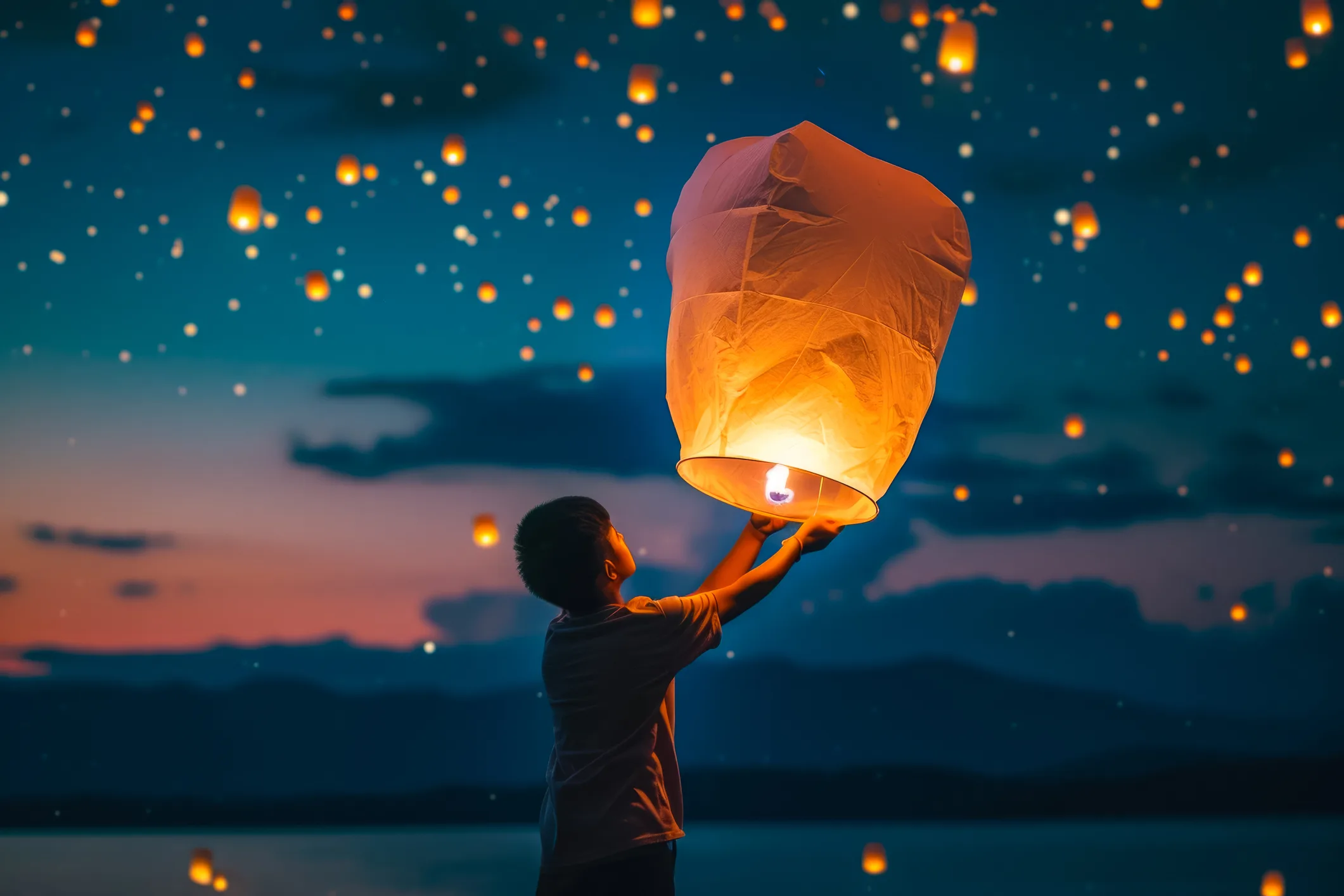 Child releasing a glowing sky lantern into the night sky, symbolizing the power of letting go and creating space for new beginnings.