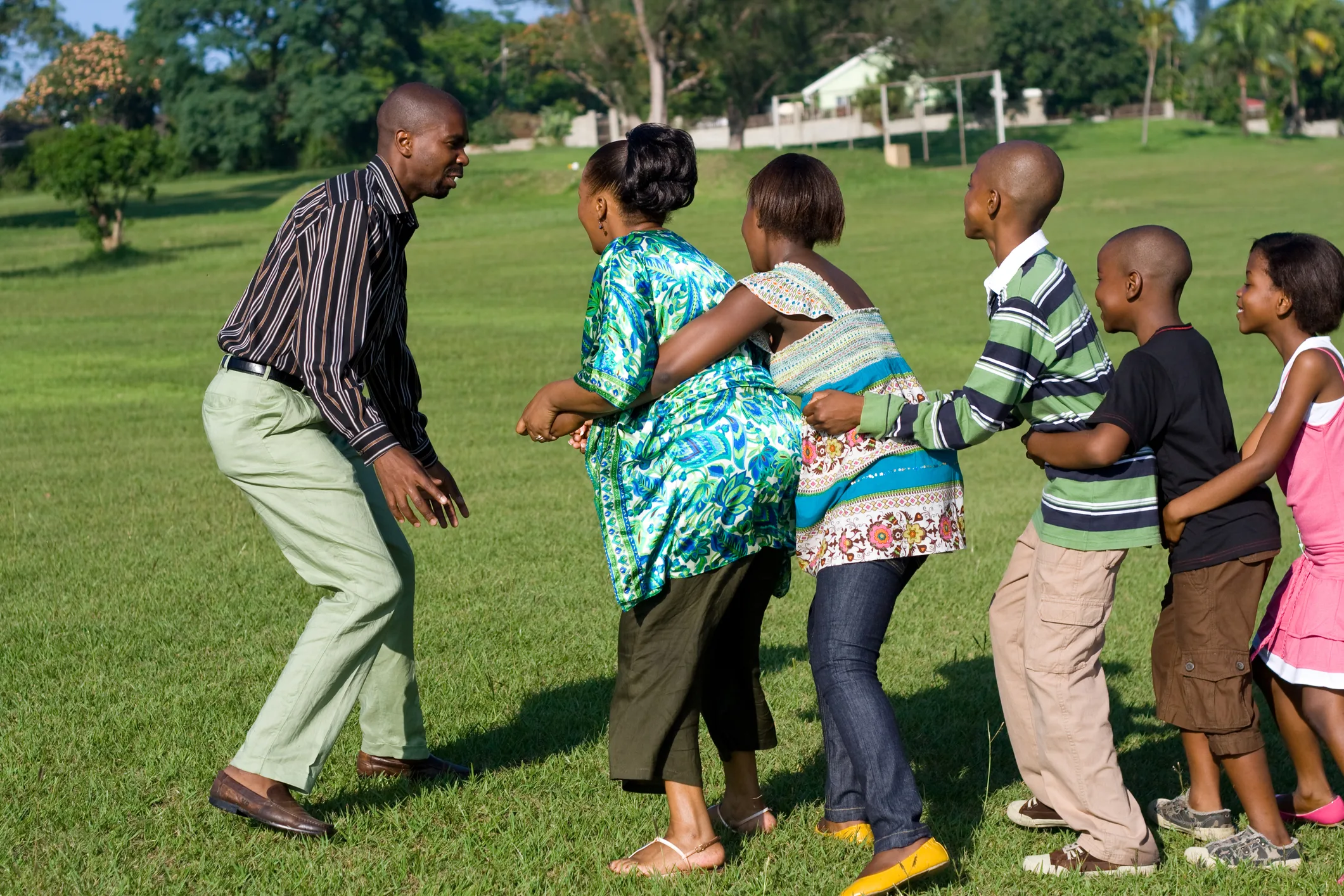 African family playing together outdoors, symbolizing unity and the resilience of family businesses growing across generations.