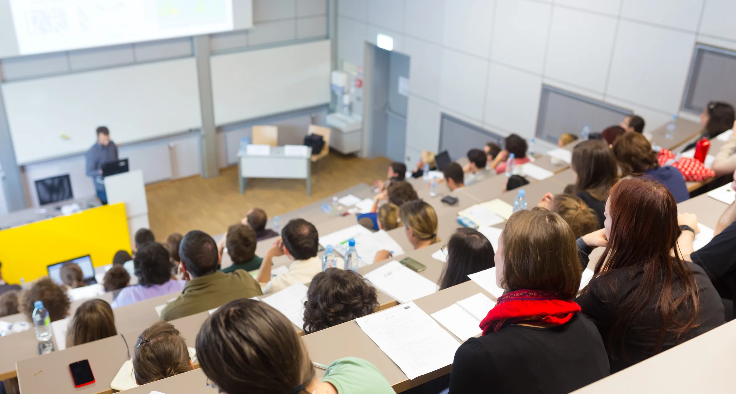 University classroom full of students listening to a lecture, reflecting Europe’s growing demand for educational qualifications.