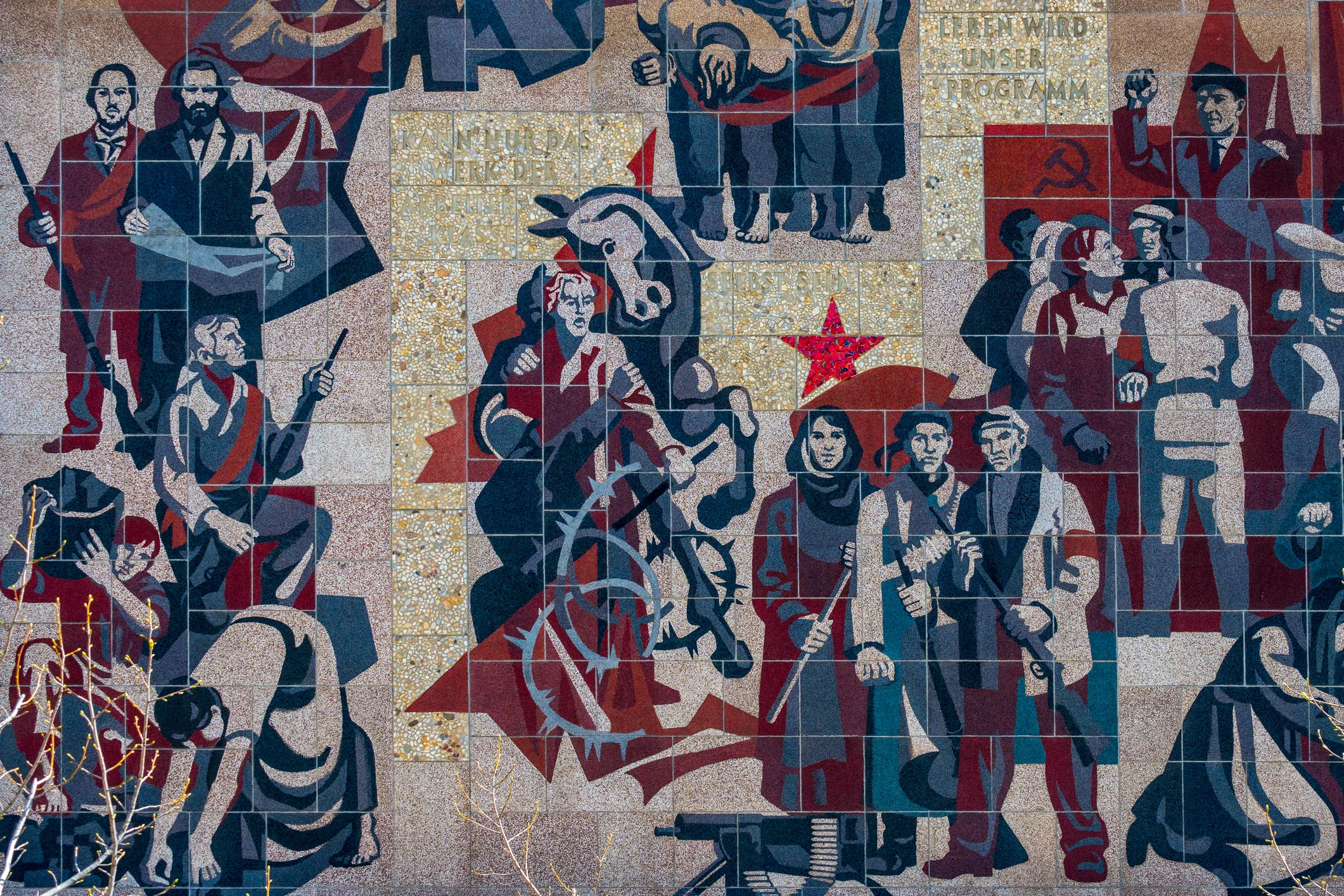 Socialist-era mural showing workers and a red star, reflecting the legacy of five-year plans discussed in “Reinventing the Five-Year Plan.”
