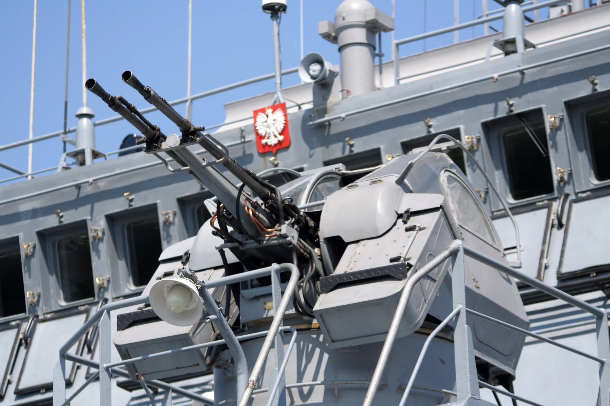 Close-up of naval gun mounted on a Polish warship, symbolizing rising defense spending and military-driven growth in Central and Eastern Europe.